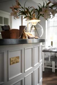 a white cabinet with a black counter top in a room at Kullagårdens Wärdshus in Mölle