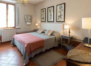 a bedroom with a bed and a table and a desk at Podere Milla in Montale