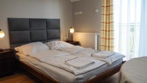 Postel nebo postele na pokoji v ubytování Willa Arkadia