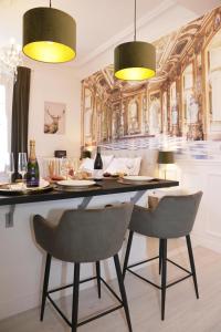 a dining room with a table and two chairs at La Marquise - Cosy Flat - Jacuzzi - Senlis in Senlis