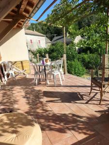 a patio with a table and chairs on it at Le devezou Malons et Elze in Malons-et-Elze