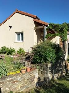 a house with a stone retaining wall in front of it at Le devezou Malons et Elze in Malons-et-Elze