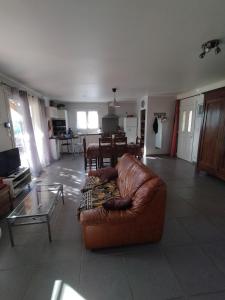 a living room with a couch and a table at Le devezou Malons et Elze in Malons-et-Elze +7 photos