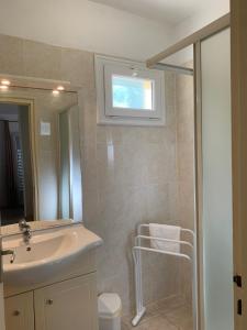 a bathroom with a sink and a mirror at Les Asphodèles in Partinello +74 photos
