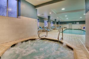 a hot tub in a hotel room with a swimming pool at Holiday Inn Express & Suites - Lincoln East - White Mountains, an IHG Hotel in Lincoln