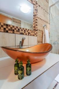 a wooden bowl sink on a counter in a bathroom at Alexa's Sunny Days in Limenaria