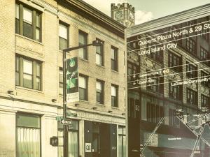 a black and white photo of a building with a street sign at Q4 Hotel and Hostel in Queens