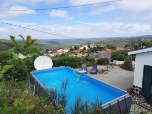 a swimming pool with a view of a house at Casa-Estaro in Anceriz