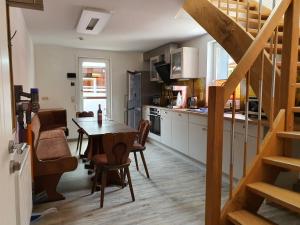 a kitchen and dining room with a table and chairs at Numero1-Pension und Cafe in Rübeland