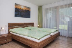 a bedroom with a bed and a large window at Ferienhaus Casa Luna in Zermatt