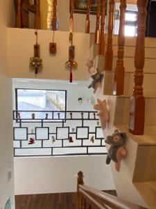 a stairwell with a wall with stuffed animals on it at Jiufen Yunhai Yazhu Homestay in Jiufen