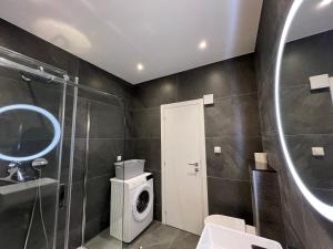 a bathroom with a sink and a washing machine at Apartments Adriatic Blue in Dubrovnik
