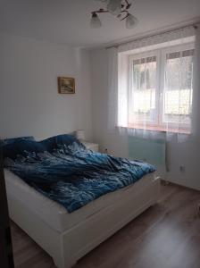 Posteľ alebo postele v izbe v ubytovaní Sielankowy Domek