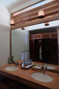 baño con 2 lavabos y espejo grande en Private Luxury Villa Celagi - with large infinity pool and ocean view en Amed