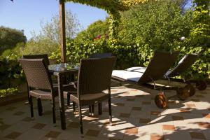 a table and chairs sitting on a patio at Costa Dorada in Cala Gonone