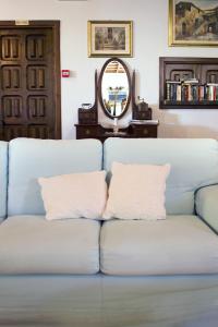 a blue couch in a living room with a mirror at Costa Dorada in Cala Gonone