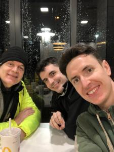 trois hommes assis à une table posant une photo dans l'établissement Maintenance, Transport, Medical Teams Bargain, 3 Bed Detached House, Mold, Sleeps 1 to 5, à Mold