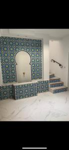 a bathroom with a blue and white tile wall at Riad Didiss Tetouan in Tetouan