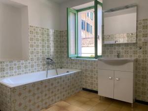 a bathroom with a large tub and a window at Villa Verde in Valsolda +61 photos