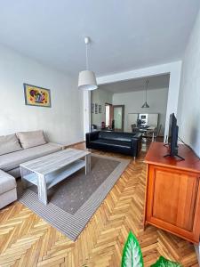 a living room with a couch and a table at IMG Apartment in Sofia