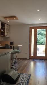a room with a kitchen with a table and a door at Apartments Adri, Parking in the yard in Rovinj