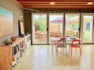 a dining room with a table and chairs with a view at Casale Artemisia Capalbio in Capalbio