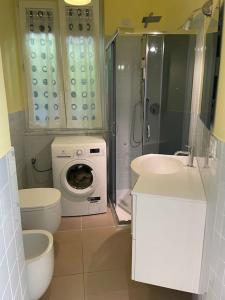 a bathroom with a shower and a washing machine in it at Ocean View Villa with Fast WI-FI and Elevator to Town in Levanto