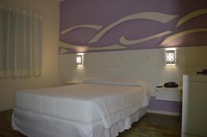 Ένα ή περισσότερα κρεβάτια σε δωμάτιο στο 27 Praia Hotel - Frente Mar