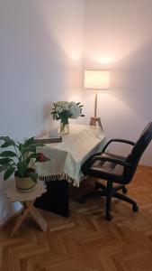 a desk with a table with a chair and a lamp at Moon Tree *** in Varaždin
