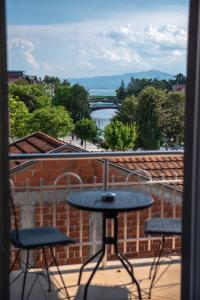 a table and chairs on a balcony with a view at Hotel Roma in Struga