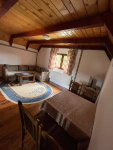 a living room with a table and a couch at Bungalows Krstajić in Žabljak