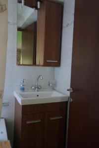 a bathroom with a sink and a mirror at To Asteri in Avgonyma +84 photos