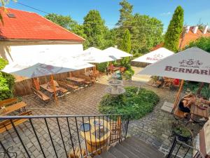 an overhead view of a patio with tables and umbrellas at Penzion & Wellness Zoborska in Nitra