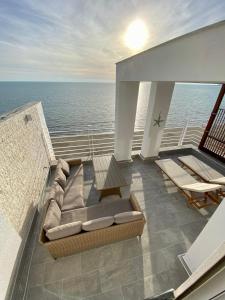 balcón con sofá y vistas al océano en Luxury Penthouse with Full Sea View, en Durrës