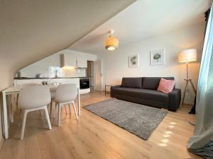 a living room with a couch and a table at Cityapartment SB Am Homburg in Saarbrücken