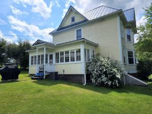 a white house with a large yard at BaseCampWV-Durbin. Spacious 4 bedroom house w/yard in Durbin