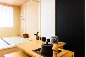 a living room with a table and a window at vacation rental SARAKU 茶楽来 in Osaka