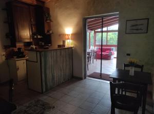 a kitchen with a door open to a living room at La Casetta B&B in Milazzo