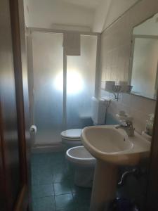 a bathroom with a white toilet and a sink at La Casetta B&B in Milazzo
