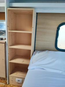 een bed in een kamer met een houten bedframe bij Hostel Trobenta in Oblak in Portorož