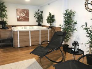 a chair in a living room with a bath tub at Golf Hotel in Riccione