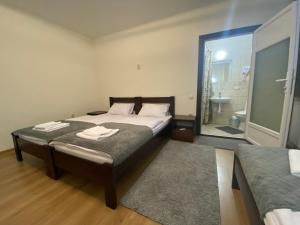a bedroom with a large bed and a bathroom at SzaboFFcsik in Uzhhorod