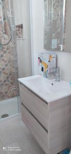 a white bathroom with a sink and a shower at Villa Francesca Appartamento Meraviglioso in Polignano a Mare +15 photos