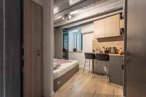 a small apartment with a bed and a kitchen at Guest House Blue in Zadar