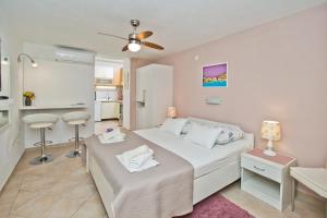 a small bedroom with a bed and a desk at Apartments Jure in Hvar