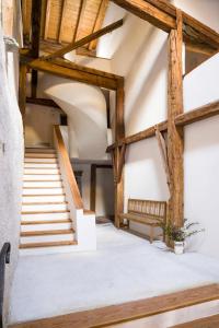 a staircase in a building with wooden beams at Hotel Chasa Chalavaina in Müstair