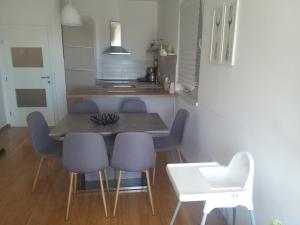 a dining room table and chairs in a kitchen at Malik's place in Novalja