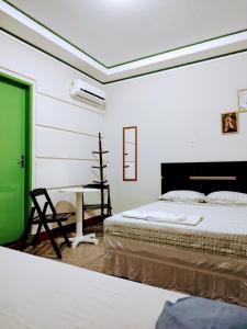 Ένα ή περισσότερα κρεβάτια σε δωμάτιο στο Pousada e restaurante portofolhense