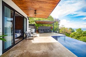 a house with a swimming pool and a bedroom at Casa Anna Santa Teresa in Santa Teresa Beach
