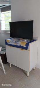 a flat screen tv sitting on top of a desk at Villa Francesca Appartamento Meraviglioso in Polignano a Mare